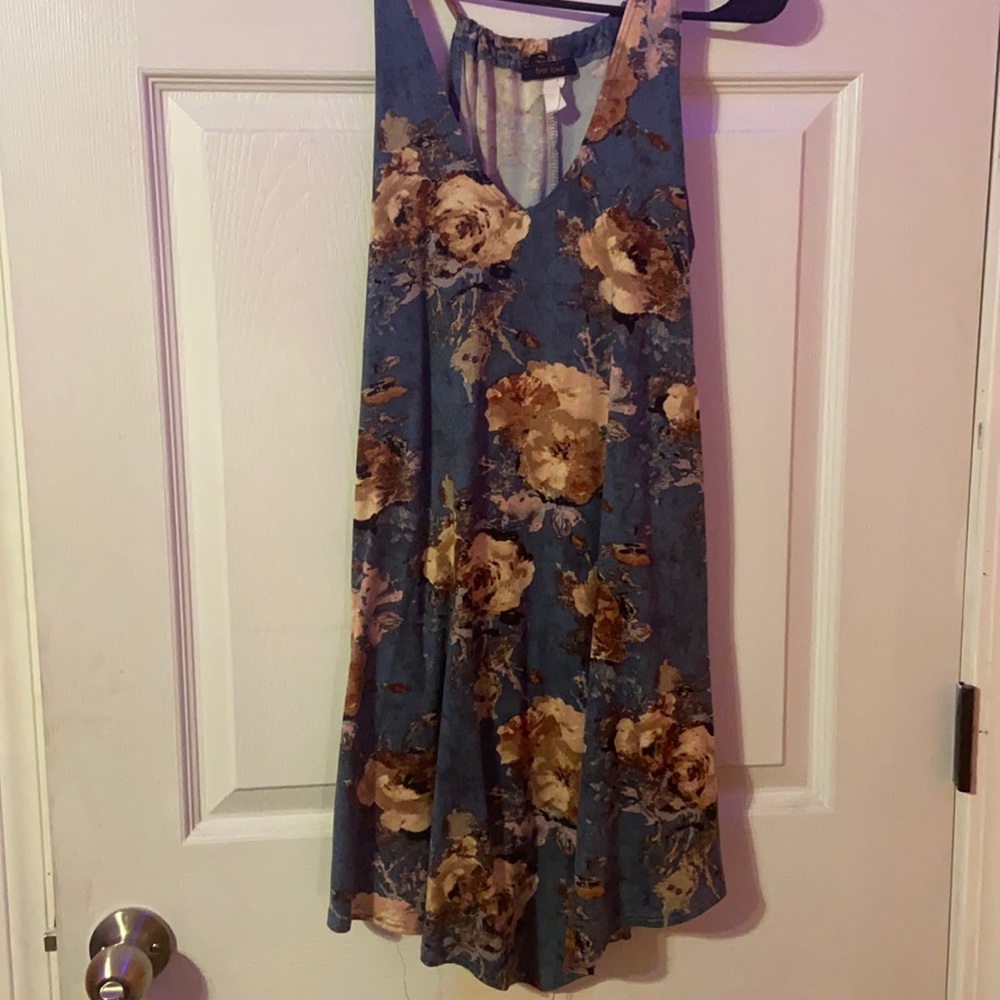 a tealish dress with multi colored flowers